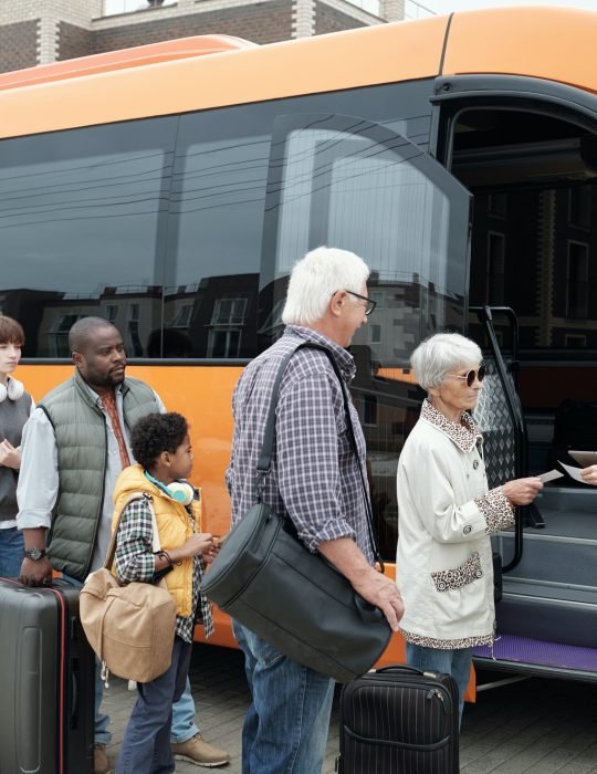 young-bus-conductor-checking-tickets-by-open-door-of-vehicle.jpg